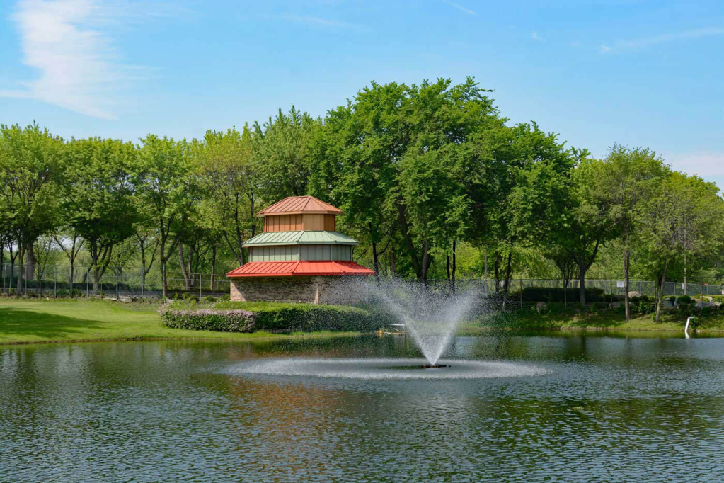 9 Hole golf course with fountain and house near trees